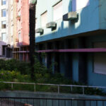 Colorful high-rise apartment buildings on Rua António José da Costa featuring composite material walls, multiple balconies, and large windows for daylighting.