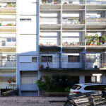 Colorful high-rise apartment buildings on Rua António José da Costa featuring balconies and extensive daylighting in an urban condominium setting designed by Unknown Architect.