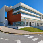 Unknown Architect’s Complexo Pedagógico III at Universidade do Minho showcasing a brutalist architecture style with composite material façade, extensive daylighting, and urban design elements including shaded areas and community centre features.