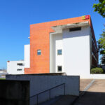 Unknown Architect’s Escola de Economia e Gestão at Universidade do Minho showcasing a modern composite material wall with clean lines and minimalist architectural design.