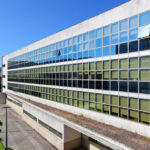 Unknown Architect’s Escola de Engenharia I at Universidade do Minho showcasing a modern commercial building with composite materials, aluminium façade, extensive daylighting, and integrated shading elements within a campus setting.
