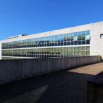 Unknown Architect’s Escola de Engenharia I at Universidade do Minho showcasing a concrete and composite material façade with clean lines and urban design elements under daytime lighting.