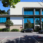 Unknown Architect’s Restaurante Panorâmico at Universidade do Minho showcasing a modern commercial building with extensive glass façades, daylighting features, and a sleek urban design emphasizing community and corporate headquarters functions.