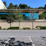 Unknown Architect’s Restaurante Panorâmico at Universidade do Minho showcasing a concrete structure with composite materials, shaded areas, extensive daylighting, and surrounding landscaping during daytime.