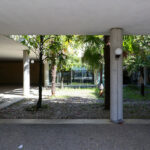 Unknown Architect’s Restaurante Panorâmico at Universidade do Minho showcasing concrete columns supporting a shaded walkway with daylighting over a central courtyard.
