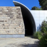 Unknown Architect’s Serviços de Ação Social at Universidade do Minho showcasing a concrete composite structure with shaded walkways, integrated landscaping, and ample daylighting.