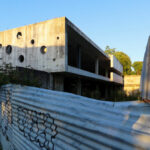 Unfinished House Rua Gustavo de Sousa by Unknown Architect showcasing brutalist architecture with exposed concrete walls, composite materials, and large openings for natural daylighting.