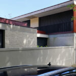 Unknown Architect’s Villa Rua de José de Carvalho showcasing a modern residential home with a composite material façade, concrete siding, and a prominent entrance door.