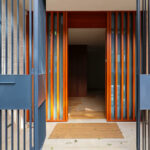 Unknown Architect’s Villa Rua de José de Carvalho showcasing a modern design with stained hardwood planks, composite materials, metal accents, and a varnished wooden gate.