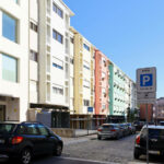 Colorful buildings of Rua António José da Costa showcasing a vibrant urban residential area with mixed-use apartments and modern architectural design in a metropolitan neighborhood.