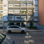 Unknown Architect’s colorful buildings of Rua António José da Costa showcasing vibrant facades with balconies and mixed-use residential apartments in an urban neighborhood during daytime.