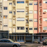 Unknown Architect’s colorful apartment buildings on Rua António José da Costa featuring high-rise condominiums with concrete structures, composite materials, and balconies in an urban design setting.