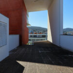 Unknown Architect’s Complexo Pedagógico III at Universidade do Minho showcasing a daytime view of a composite material and steel structure with balconies and extensive daylighting features.