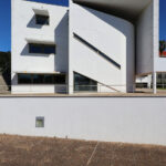 Unknown Architect’s Escola de Economia e Gestão, Universidade do Minho showcasing brutalist architecture with concrete and composite materials, featuring plaster balconies and dynamic daylighting creating distinct shadows.
