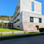 Unknown Architect’s Escola de Engenharia I at Universidade do Minho showcasing a brutalist concrete structure with angular forms and an urban design layout on a land lot.