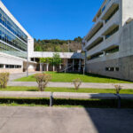 Unknown Architect’s Escola de Engenharia I at Universidade do Minho showcasing a concrete corporate headquarters with shaded walkways and urban campus design elements.