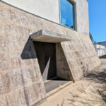 Unknown Architect’s Escola de Engenharia I at Universidade do Minho showcasing a grey concrete and composite material façade with plaster and cement finishes, highlighted by daylighting and shadow effects.
