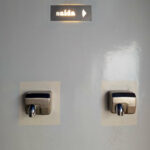 Shower House Parque da Cidade by Unknown Architect showcasing a sleek silver exterior with modern technological design elements and clean geometric lines.