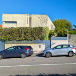 Unknown Architect’s Villa 1 Rua Pinho Leal showcasing a modern residential design with a sleek façade, integrated automotive parking area, and surrounding suburban landscape.