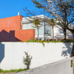 Unknown Architect’s Villa IV Rua Júlio Dantas showcasing a residential building with composite material walls, brick accents, balconies, and large windows designed for optimal daylighting in an urban setting.