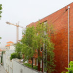 Unknown Architect’s Villa Rua do Farol showcasing a brick wall exterior with clean, modern lines.