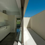 Nuno Brandao Costa’s 7 Houses in Óbidos at Bom Sucesso Resort showcasing interior design with grey concrete flooring, composite material tiles, and daylighting highlighting the ceiling and floor assemblies.