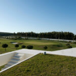 Nuno Brandao Costa’s 7 Houses in Óbidos at Bom Sucesso Resort showcasing modern landscaping, daylighting effects, shadows cast on walkways, and integrated outdoor spaces.
