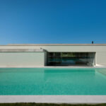Nuno Brandao Costa’s 7 Houses in Óbidos at Bom Sucesso Resort showcasing modern architecture with concrete and composite material flooring, tiled surfaces, daylighting, and a swimming pool integrated into the shaded outdoor design.