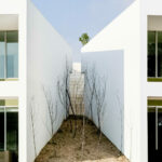 Nuno Graça Moura’s 24 Row Houses at Bom Sucesso Resort showcasing a modern design with extensive daylighting through large windows and clean, linear façades.