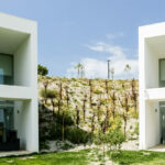 Nuno Graça Moura’s 24 Row Houses at Bom Sucesso Resort showcasing modern villas with landscaped surroundings and clean, geometric façades.