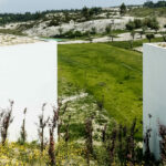 Nuno Graça Moura’s 24 Row Houses at Bom Sucesso Resort showcasing modern linear structures with extensive glass façades surrounded by lush green plantations and open fields.