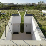 Nuno Graça Moura’s 24 Row Houses at Bom Sucesso Resort showcasing an urban design with interconnected walkways, extensive daylighting, and dynamic shadow patterns on the modern façades.
