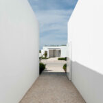 Nuno Graça Moura’s Bar Code 1 - 30 Row Houses at Bom Sucesso Resort showcasing a modern design with composite material and concrete construction, featuring landscaped courtyards, walkways, driveways, and daylighting elements around villa-style estates.