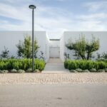 Nuno Graça Moura’s Bar Code 1 - 30 Row Houses at Bom Sucesso Resort showcasing modern landscaping with garden spaces, daylighting features, and sleek architectural design.