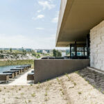 Nuno Graça Moura’s Golf Clubhouse at Bom Sucesso Resort showcasing a composite material exterior with large daylighting elements enhancing natural light inside.