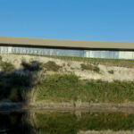 Nuno Graça Moura’s Golf Clubhouse at Bom Sucesso Resort showcasing a modern design with extensive daylighting and integration of wetland surroundings.