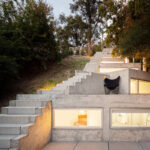 Álvaro Leite Siza Vieira Jr’s Casa Tóló showcasing concrete stairs with composite material elements and dynamic shadow play.