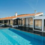 Antonio Corte-Real’s Maison de Vacances Esposende showcasing a modern villa with a composite material façade, integrated swimming pool, and shaded outdoor living spaces.