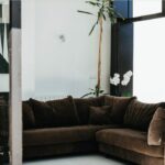 Antonio Corte-Real’s Maison de Vacances Esposende interior showcasing a modern living room with minimalist furniture, textile couch, wooden flooring, and ambient lighting.