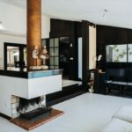 Antonio Corte-Real’s Maison de Vacances Esposende interior showcasing modern living room design with sleek flooring, minimalist furniture, recessed ceiling lighting, and open architectural layout.