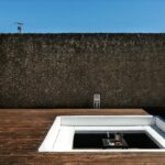 Antonio Corte-Real’s Maison de Vacances Esposende showcasing a composite material and concrete structure with tiled surfaces, daylighting effects, and dynamic shadow patterns.