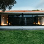 Antonio Corte-Real’s Maison de Vacances Esposende showcasing a modern villa with a shaded balcony, extensive use of daylighting, and eco-friendly outdoor structures.
