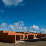 Atelier dos Remédios, Madalena Cardoso de Menezes and Francisco Teixeira Bastos’ 18 Red Row Houses at Bom Sucesso Resort featuring composite material façades with distinct shadows and optimized daylighting.