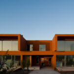 Atelier dos Remédios, Madalena Cardoso de Menezes and Francisco Teixeira Bastos’ 18 Red Row Houses at Bom Sucesso Resort featuring concrete construction with composite materials and balconies.