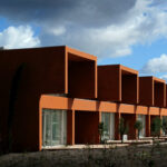 Atelier dos Remédios, Madalena Cardoso de Menezes, and Francisco Teixeira Bastos’ 18 Red Row Houses at Bom Sucesso Resort featuring a composite material façade with concrete elements, urban design layout, and large windows optimizing daylighting.