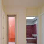 Atelier dos Remédios, Madalena Cardoso de Menezes, and Francisco Teixeira Bastos' 18 Red Row Houses at Bom Sucesso Resort featuring brown wood-stained walls and flooring with composite materials and a wooden ceiling.