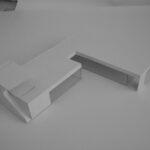 Josep Llinás’s House Model 2 showcasing a modern interior with a plywood writing desk, composite material flooring, and minimalist furniture design.