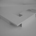 Josep Llinás’s House Model 2 showcasing a minimalist design with plywood surfaces and a modern desk integrated into the interior space.
