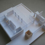 Josep Llinás’s House Model 3 showcasing an open floor plan with plywood flooring and minimalist wooden structural elements.