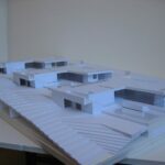 Josep Llinás’s House Model 3 showcasing a detailed scale model with composite materials, urban design elements, and architectural plans visible.